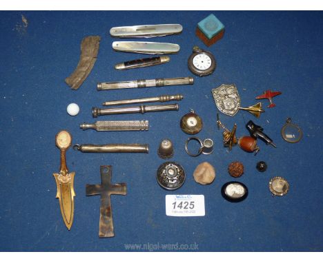 A collection of miscellanea to include; mother of pearl knives, turtle shell crucifix, silver school badge, miniature compass