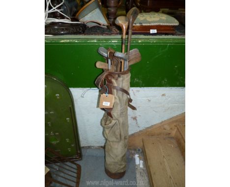 A vintage canvas and leather Golf bag containing 15 antique Hickory golf Clubs including The New "Mills" R.N.G. model medium.