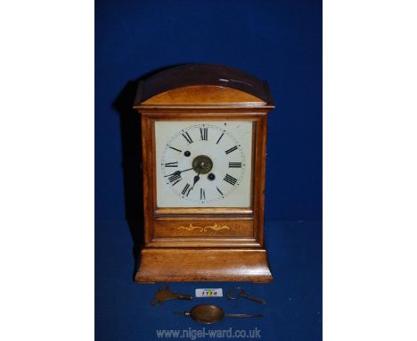 A mantle Clock by W &amp; H Sch with white enamel face, 11 3/4'' tall, with pendulum and key