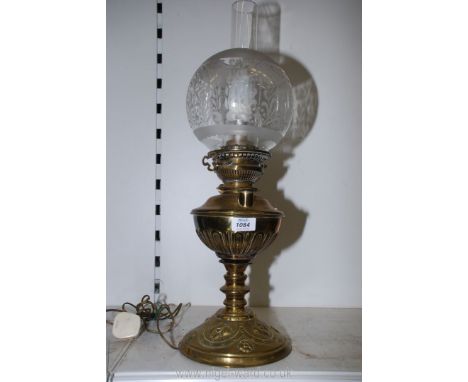 A brass based Oil Lamp with chimney and globe shade, converted to electric, 24'' tall.[working at time of lotting]