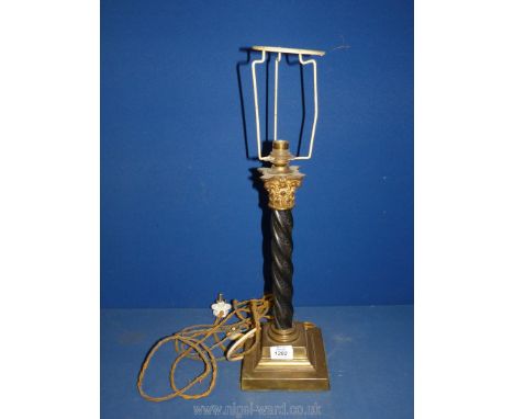 A black metal and brass Table Lamp in reeded column form with ornate top, 12'' tall.