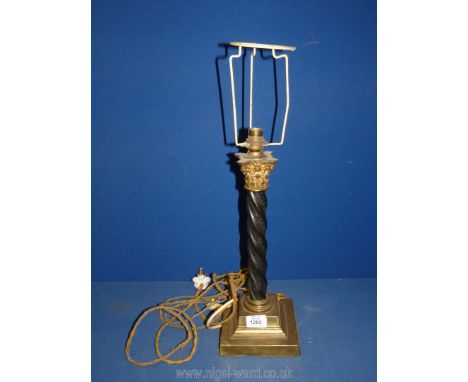 A black metal and brass Table Lamp in reeded column form with ornate top, 12'' tall.