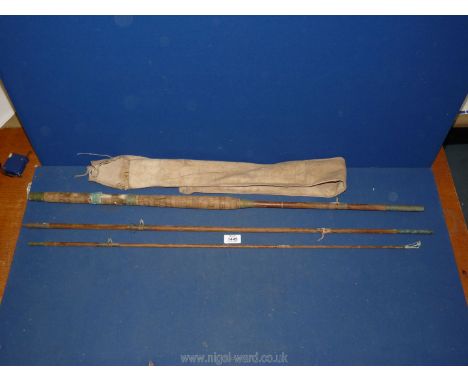 A three piece vintage wooden fly rod with two handed salmon handle in cork with brass fittings, significant signs of use and 