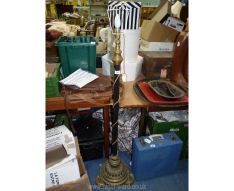 An unusual Standard Lamp with brass base on three feet, black metal reeded column and brass top, 55'' tall.  