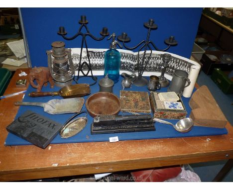 A box of miscellanea including candelabra, Victorian pewter items, fireside shovels, oil lamp etc.