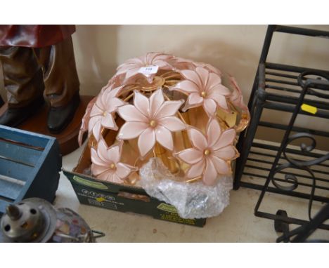 A brass ceiling light decorated with glass flowers