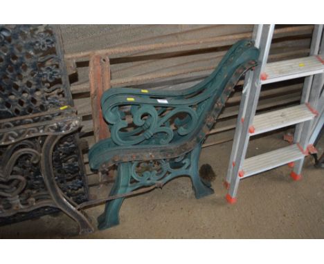 A pair of green painted garden bench ends