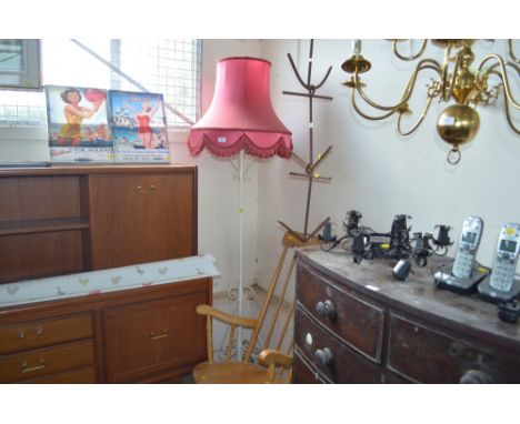 A wrought iron standard lamp and shade