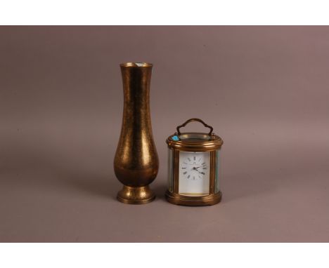 A mid 20th century oval brass carriage timepiece, together with a Middle Eastern brass vase lamp base, 31cm (2)