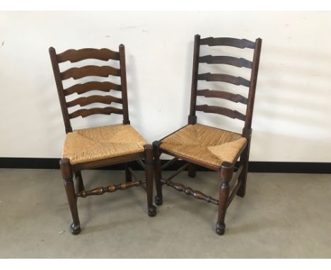A pair of modern ladder back dining chairs 