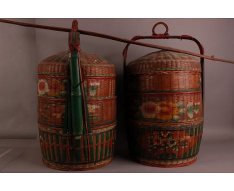 A pair of large vintage Chinese street vendor's rattan baskets, 74cm high, with some painted decoration, with a bamboo carryi