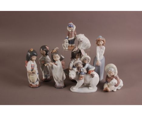 A group of nine Lladro and Nao porcelain figures, including a Nao figure of a lady, 23.5cm, a set of four Japanese Lladro you