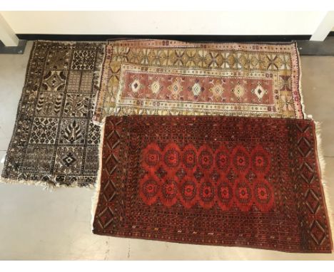 Three vintage middle eastern carpets, Including a Turkmen example, 186cm by 105 cm, with two others (3)