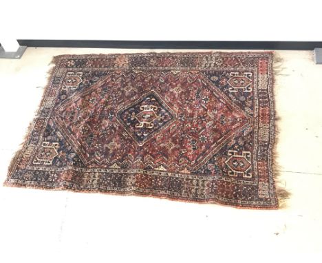 A vintage middle eastern woollen carpet,  damaged, 196 cm x 146 cm