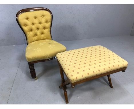 Low upholstered occasional chair / nursing chair on brass front castors with button back