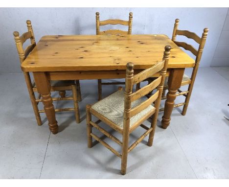 Pine kitchen table on turned legs, approx 136cm x 80cm x 76cm tall, accompanied by four ladder back chairs