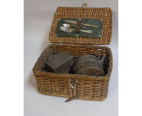 A canework picnic basket and contents of tin, cooker, kettle, two further tins, knife, fork and spoon