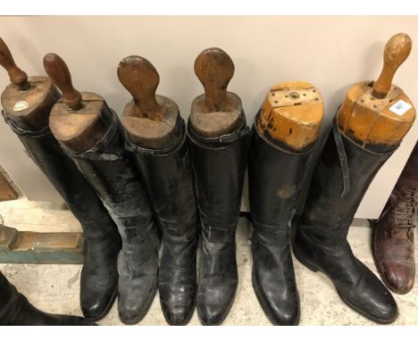 Three pairs of black leather riding boots, each with wooden trees - one tree bearing ivorine label inscribed "Tom Hill, Londo