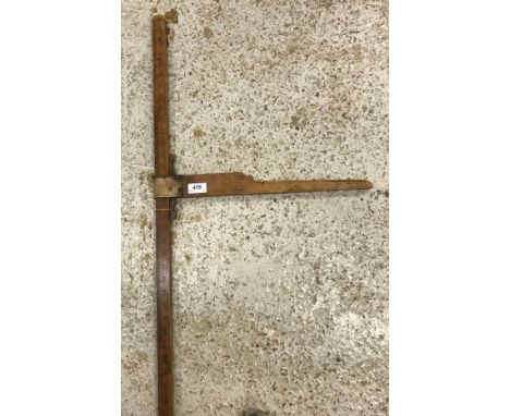 A horse measuring stick, one side inscribed "Feet", the other "Hands"