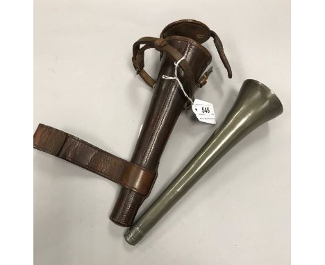 An elongated bell-shaped flask, stamped "Sykes" to both ends, housed in leather saddle holder