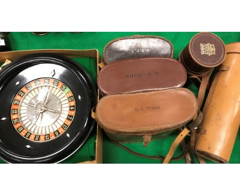 A collection of items comprising a vintage roulette wheel (boxed), three pairs of binoculars to include a Ross of London 9 x 