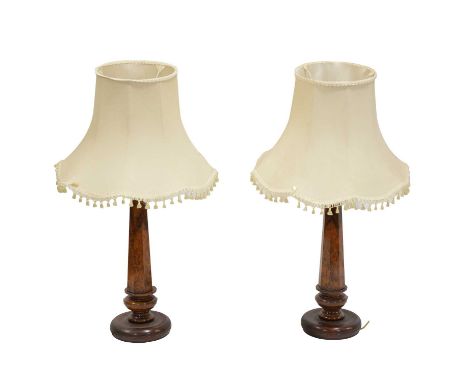 Pair of table lamps, incorporating figured walnut 'piano leg' sections, with ivory-coloured shades, overall height 98cm.