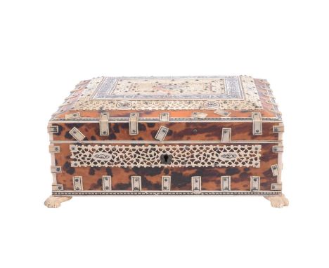 Indian bone and tortoiseshell work box, casket form with pierced bone and penwork panelling, removable tray, raised on four c