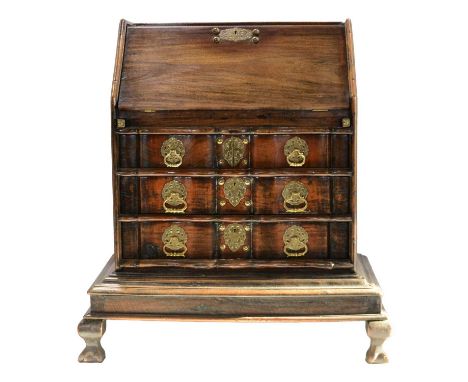 A 'Dutch Colonial' teakwood bureau, fall front enclosing a stepped interior, two short and two long drawers under, moulded pl