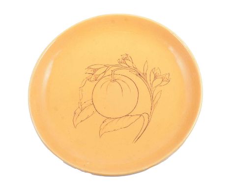 Walter Moorcroft, an ochre coloured charger drawn with tube line fruit decoration, 30cm, impressed and signed.