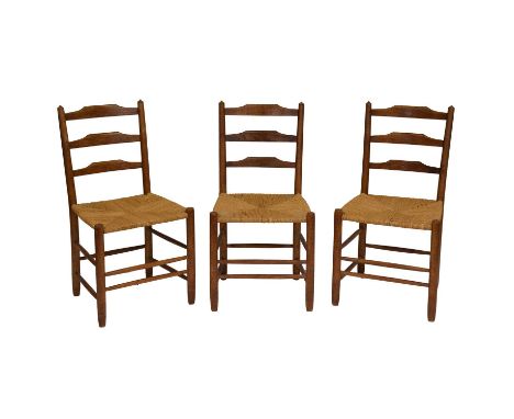 Three 'Clissett' design Arts and Crafts ladder-back chairs, probably Neale workshops to a design by Ernest Gimson, seagrass s