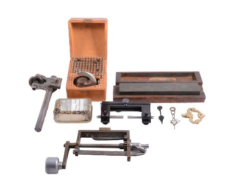 Quantity of clock- and watch-making tools and spares, including taps, gauges, a mainspring winder, etc, spare parts, hands, c