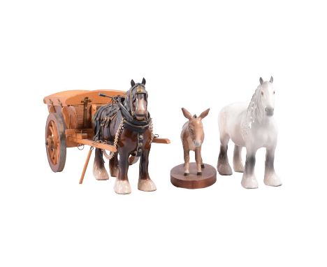 Three Beswick horse figurines: Shire horse with cart; another Shire horse, grey; and a donkey mounted on a wooden stand.