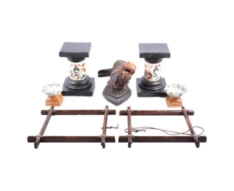 Pair of Zlonay style table pedestals, ebonised wooden plinths and bases, 22cm; a Black Forest carved gong bracket, in the for