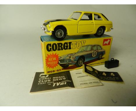 A boxed Corgi Toys No 345 MGC competition model in yellow and black, the model with black suitcase leaflet and racing numbers