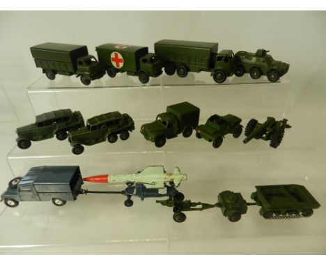 Fourteen Dinky Toy military vehicles to include 2 field cars, 1, 3 and 10 Ton lorries and a rare field tractor with trailer a