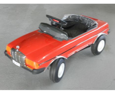 A child's pedal car modelled on a Mercedes 500 SEC dating from 1985, the car unused and still with protective, plastic to sea