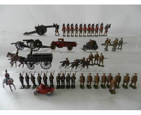 A collection of pre war Britains soldiers and equipment to include a naval canon, Howitzer, a cast iron lorry by Arcade and a