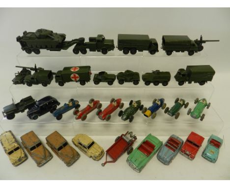 Thirty one unboxed Dinky Toys, army and saloon cars dating from the 1950s. Army vehicles include a tank transporter, covered 