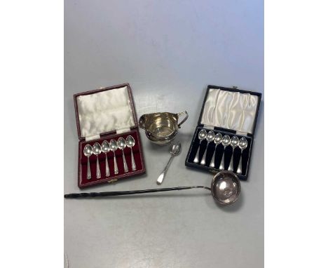 Two cased sets of silver spoons, together with a silver punch ladle, a silver teaspoon and a silver cream jug 7.8ozt gross we