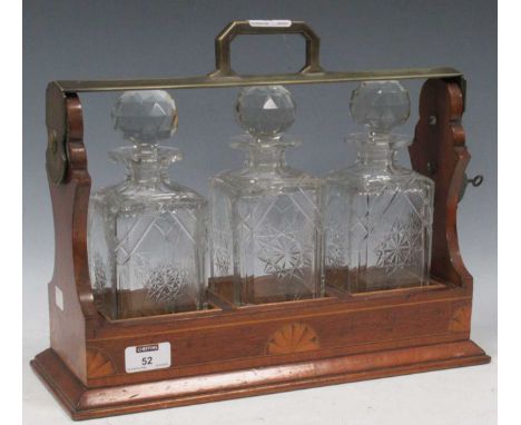 A tantalus with three cut glass decanter, the carry case with inlaid details, 31 x 40 x 15cmNot marked Betjeman