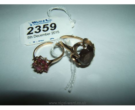 A 9ct Gold flower shaped Ruby Ring, one stone missing, and a 9ct Gold cushion set smoky Topaz Ring