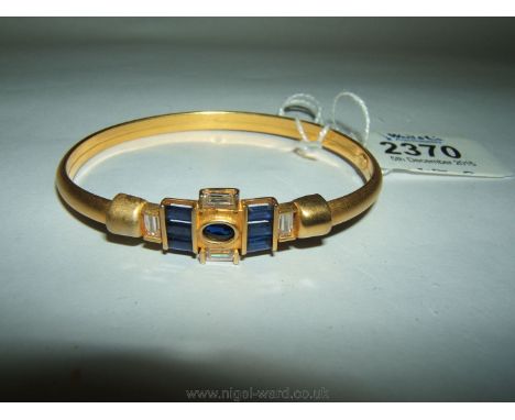 A continental 14k burnished Gold art deco style Bangle set with Sapphires and Zircon