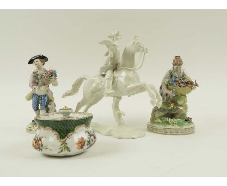 NYMPHENBURG WHITE GLAZED EQUESTRIAN FIGURE, 20cm H; two Dresden flower seller figurines, 15cm H; and a Dresden lidded inkwell