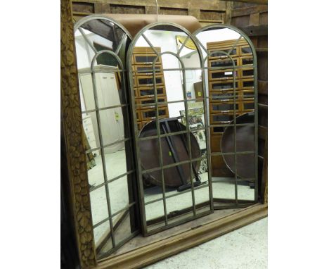 GARDEN MIRRORS, a set of three, Architectural style verdigris metal framed with an arched top, 66cm W x 159cm H. (3)