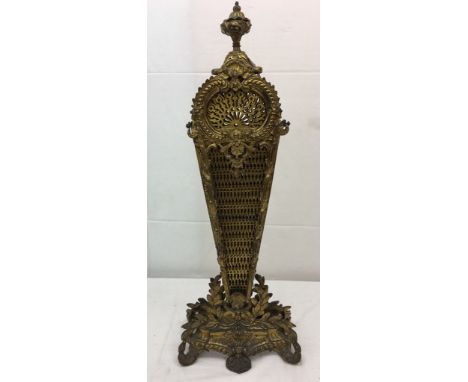 A vintage brass fan fire screen