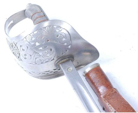 An 1897 pattern Infantry Officer's sword, the 83cm blade etched with a crowned ER VII cypher, marked faintly to the forte F.W