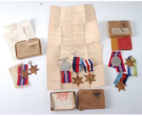 A collection of WW II medals to include 1939-1945 Star and Africa Star with Service slip in O.H.M.S. box, naming C.J.S. Andre