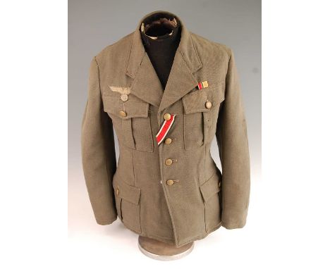 A German Army tunic, in green having four pleated pockets with pebble effect buttons and War Service Cross 2nd class medal ri