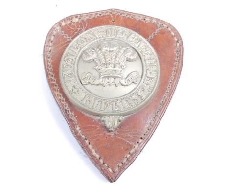 A Ceylon Mounted Rifles pouch plate, the silvered circular plate with Prince of Wales feathers, having three lugs to the reve