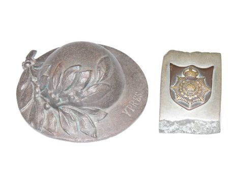 A miniature Brodie helmet embossed with laurel leaves, marked Ypres and signed J. Smit, dia.9cm, together with a piece of shr